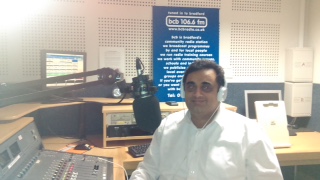 Naeem Nawaz behind the desk
