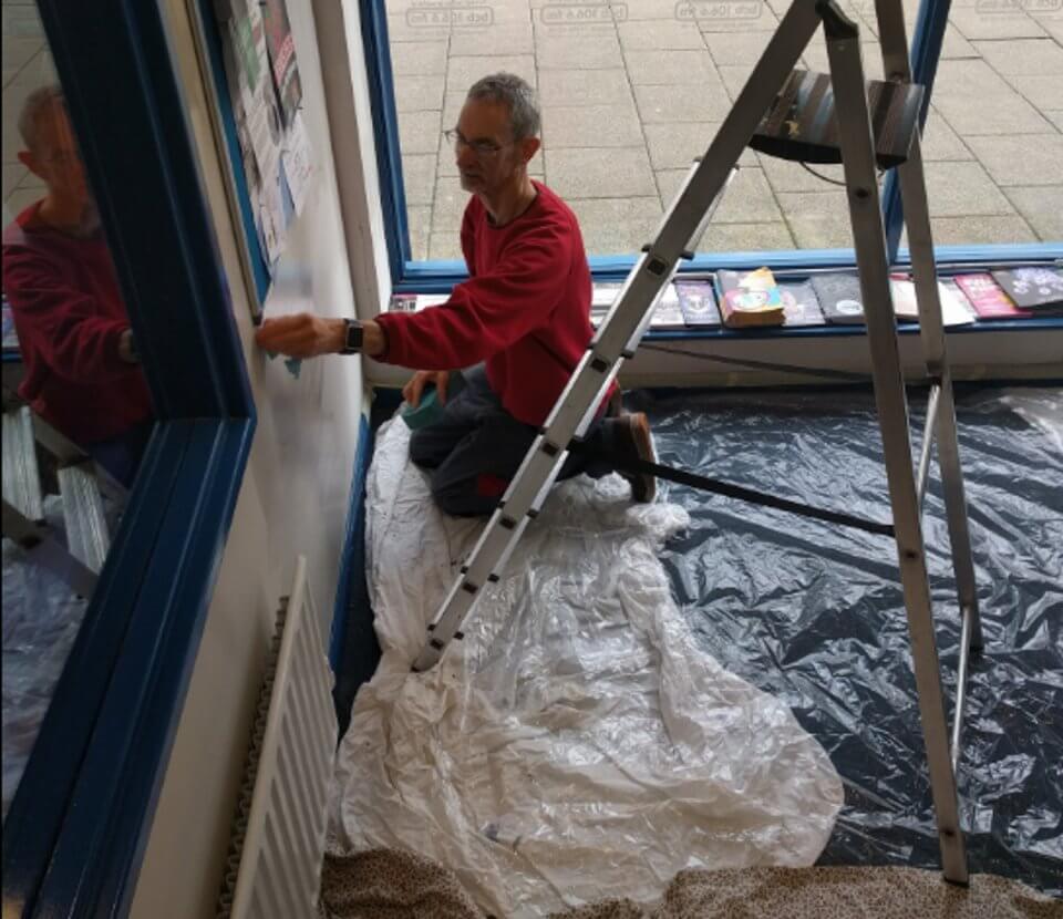 A man on the floor with paint